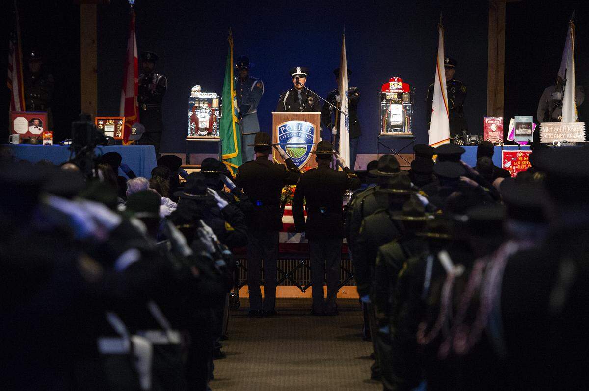 Members of the honor guard salute Lynden interim Police Chief Michael Knapp’s casket at the beginning of Knapp’s memorial service at Christ the King Community Church in Bellingham Wednesday.