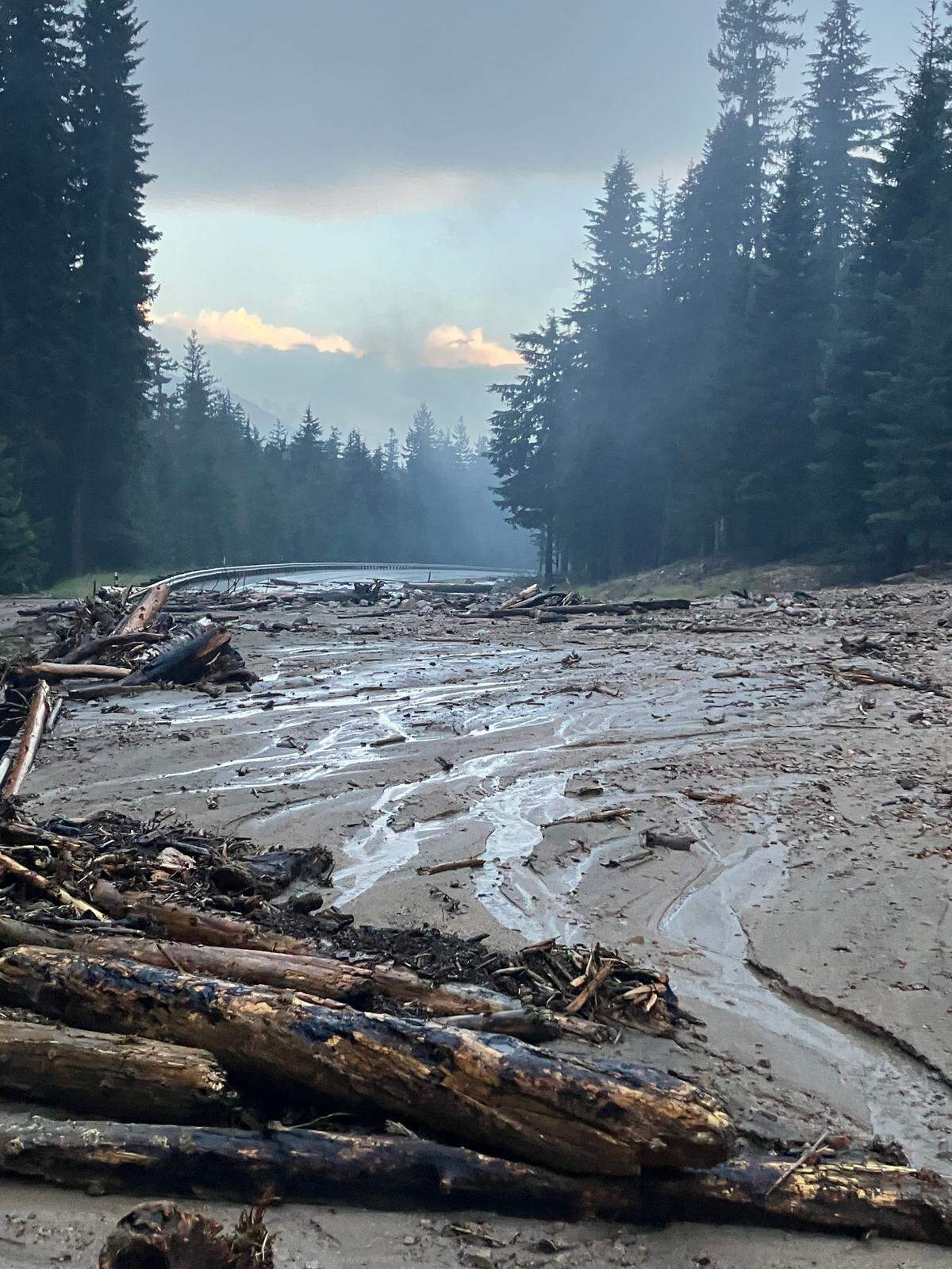 Mud, rocks and debris from the Easy Fire cover Highway 20 at mile marker 152 west of Mazama, Wash., on Monday, Aug. 12, 2024. Nearly 2 inches of overnight rain caused the slide in the fire’s burn scar.