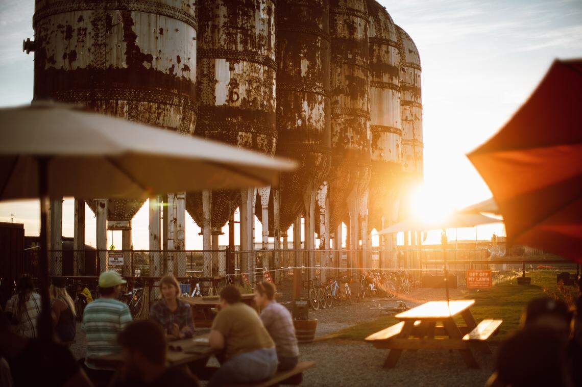 Patrons hang out at Kulshan Brewing Co’s Trackside Beer Garden at sunset.
