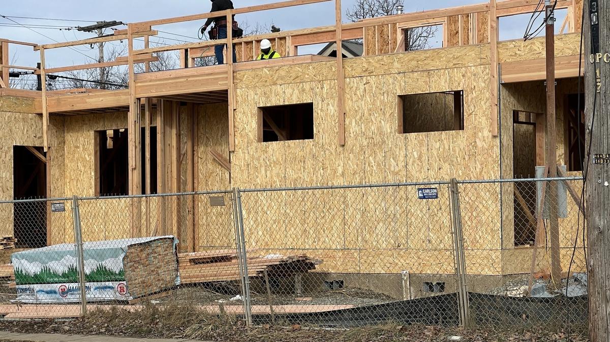 Construction workers build a duplex to replace a dilapidated house at Halleck and C streets in the Lettered Streets neighborhood of Bellingham in February.