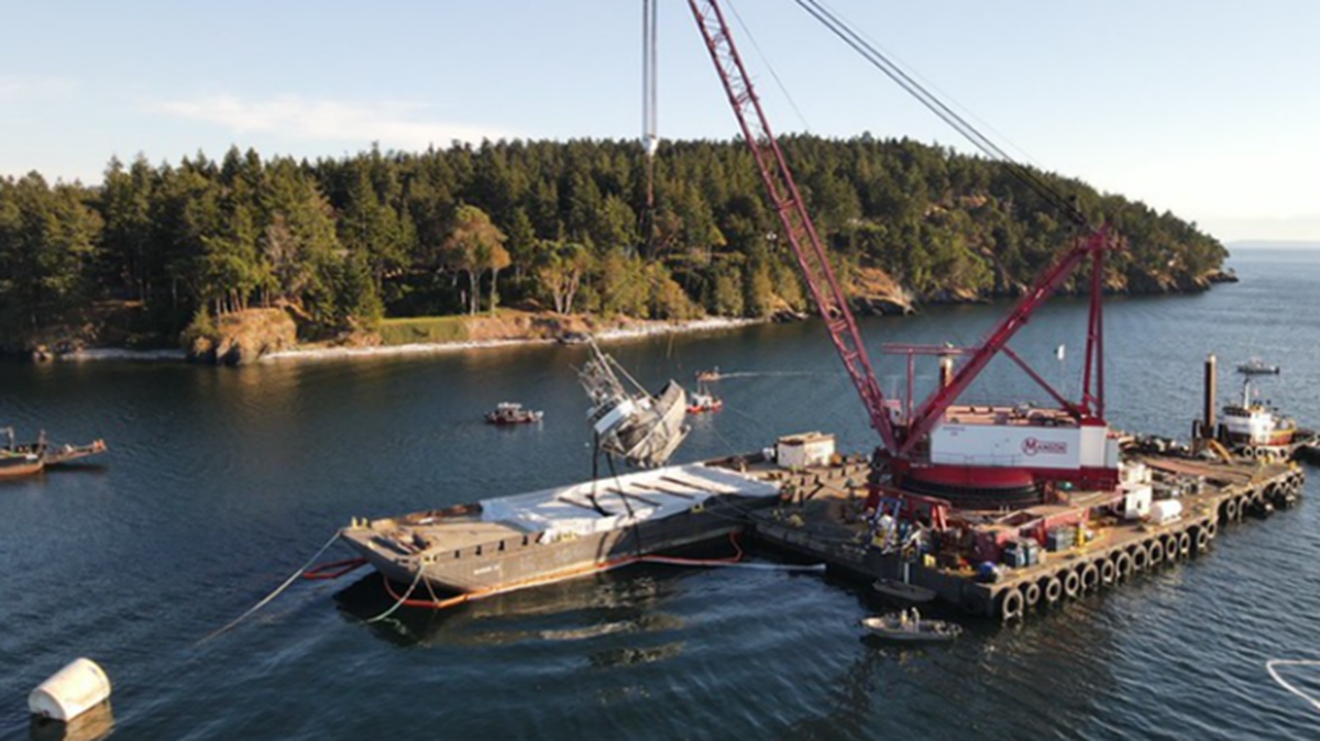 A crane lifts the Aleutian Isle onto a barge off San Juan Island on Sept. 21, 2022.