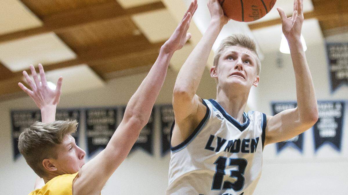 Lynden Christian’s Cole Bajema, right, shoots and scores over Lynden’s Dakota Baar Jan. 19 at Lynden Christian. Bajema now a senior announced via Twitter Friday that he has committed to play basketball for Michigan. He will be the first Whatcom boys player at a Power Five school since Luke Ridnour.
