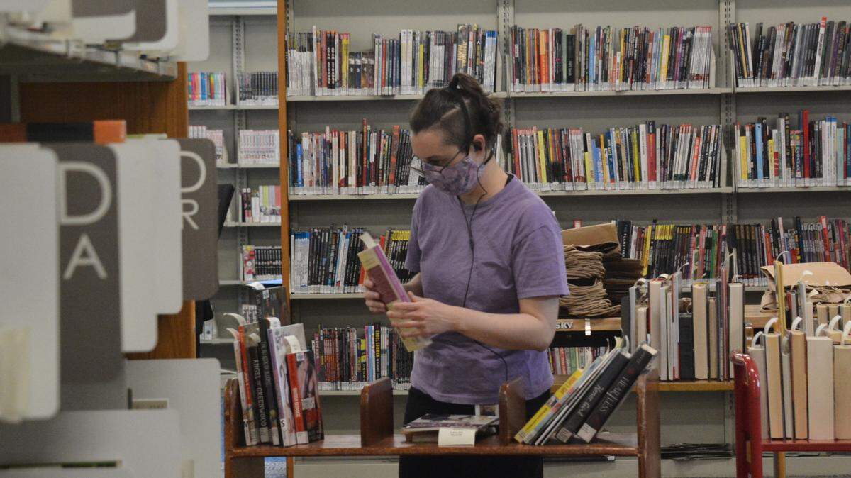 Library assistant Natalia Froberg shelves books in the popular holds section at the Bellingham Public Library i Wednesday, May 19. The main floor of the library underwent a $2.5 million remodeling project. Patrons can reserve materials online and they are placed alphabetically for easy pickup near the front entrance.