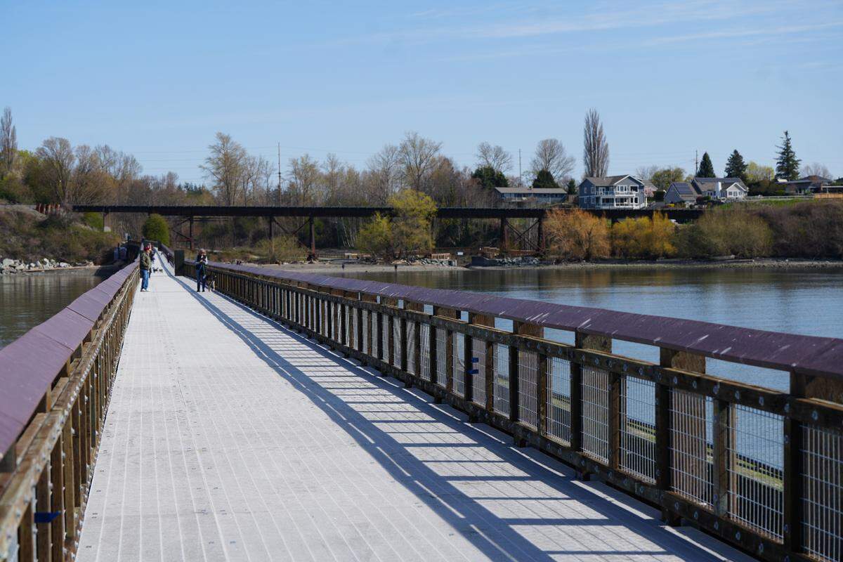 Visitors walk along Little Squalicum Pier on April 4, 2025, in Bellingham, Wash., after it opened to the public for the first time since it was built in 1912.