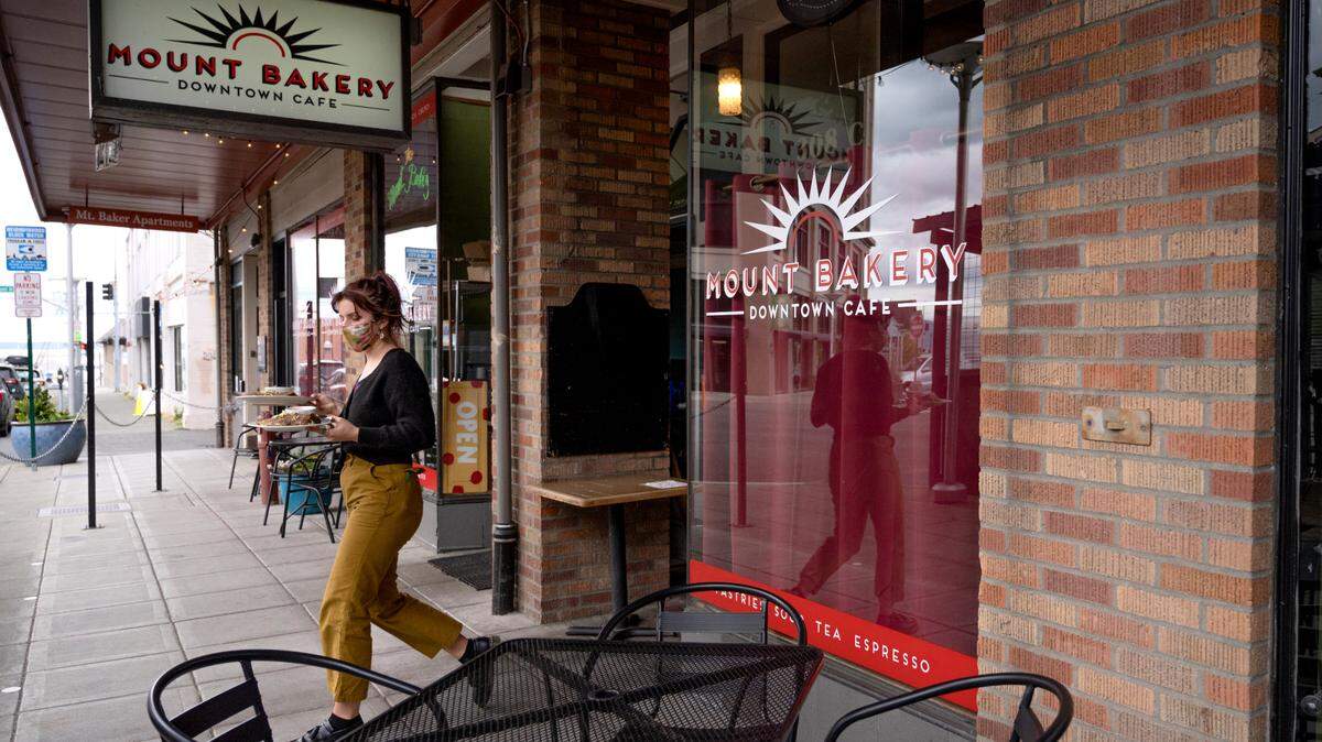 An employee at the Mount Bakery serves food on Thursday, May 27 in Bellingham. The restaurant recently had to close on Wednesdays until more staff can be hired coming out of COVID-19 restrictions.