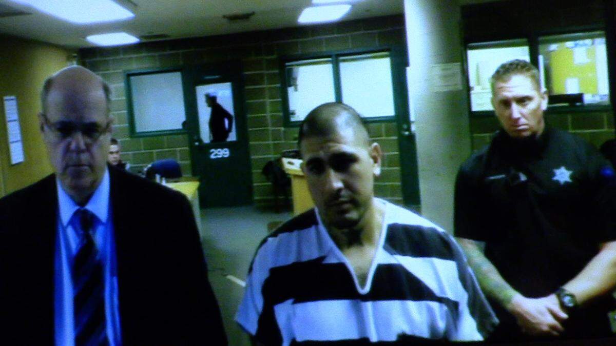 Jesse Rene Reyes, center, appears on video Monday afternoon in Whatcom County Superior Court.  He is facing charges in the stabbing death of a 71-year-old man and assaults on two other people Saturday morning in Bellingham’s Puget neighborhood. His bail was set at $1 million.