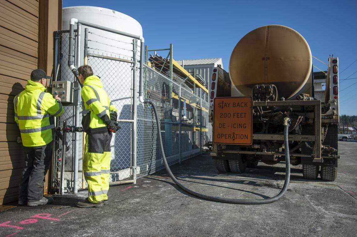 Utility workers Joe McGirr, left, and Robyn Arbogast fill the larger of the city’s two de-icing trucks with de-icing agent at the Bellingham Public Works Department building Feb. 6, 2019.