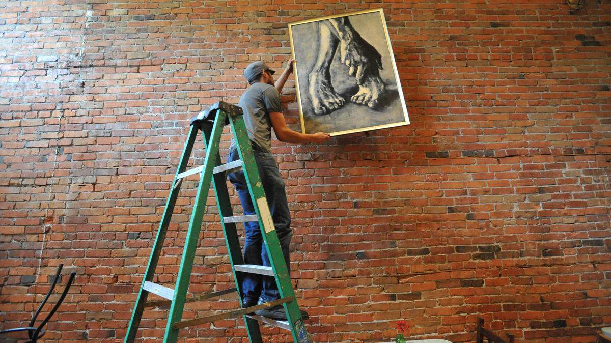 Local art and the brick wall are familiar to patrons at Brandywine Kitchen at 1317 Commercial St. in downtown Bellingham. Repairs were recently completed after a May 20 fire.