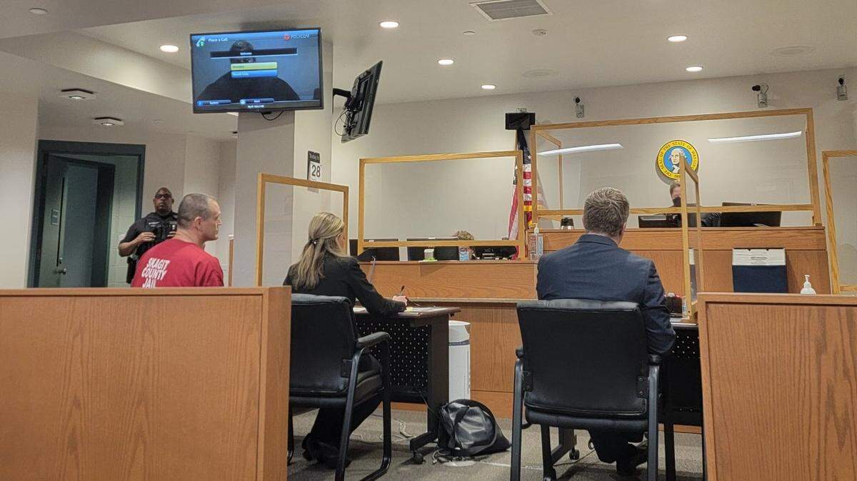 Ferndale police officer Michael Scott Langton, 46, left, makes his first appearance Thursday, July 28, in Whatcom County Superior Court in Bellingham. He was charged with one count of attempted second-degree child molestation, a felony.