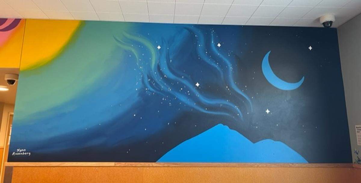 A mural at the Whatcom Triage Center depicts an evening sky with stars and a moon in Bellingham.