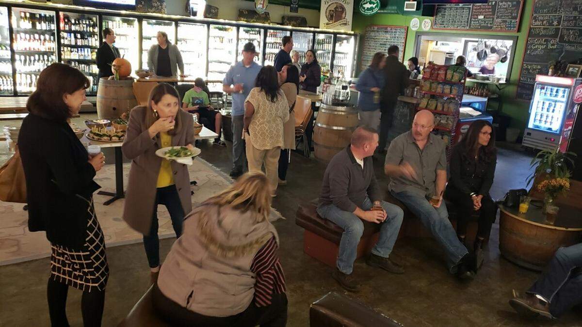 Supporters of Whatcom County Prosecuting Attorney candidate Eric Richey gather at Greene’s Corner on James Street in Bellingham Tuesday evening as they wait for election results.