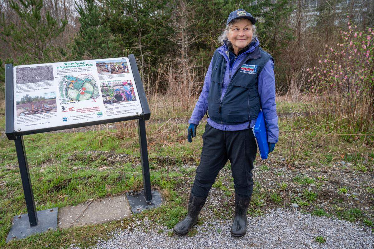 Environmental educator Wendy Scherrer waits for Alderwood Elementary students who helped release salmon fry into Willow Spring Friday, March 25, in Bellingham.