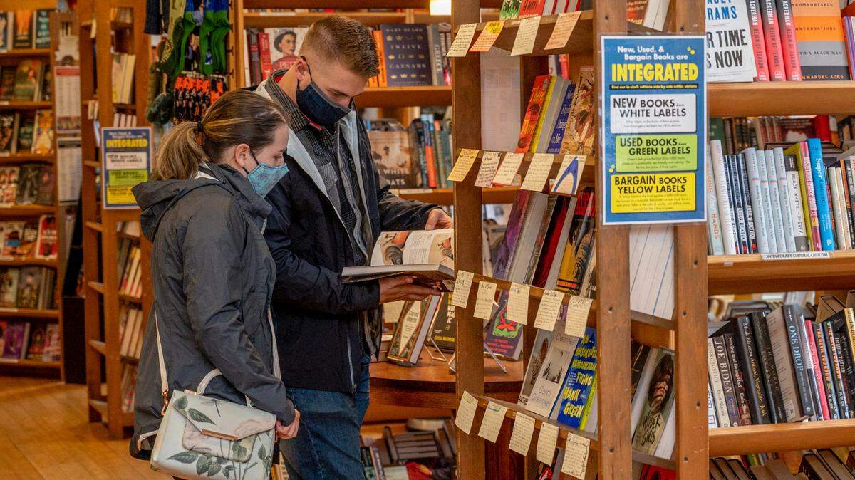 People shop for books at Village Books on Thursday, Oct. 14, in Fairhaven. Sarah Hutton, co-owner at Village Books, said they have about 80% of the inventory for Christmas gifts, but the things they haven’t received are back-ordered because of production issues.