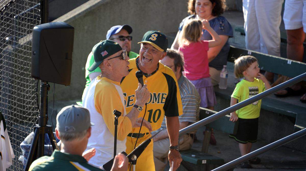 Newly retired Sehome coaching and teaching legend Gary Hatch, right, reacts to a story told by close friend and baseball colleague Bill Baker, left, during a celebration of Hatch’s career on June 29, 2015, at Joe Martin Field.