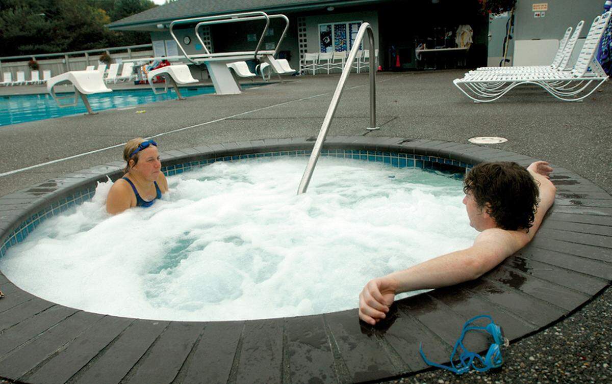 Bobbie Jaffe, left, and Kenny Moffat chat while sitting in the hot tub after a swim at Bayside Swimming Club. 
