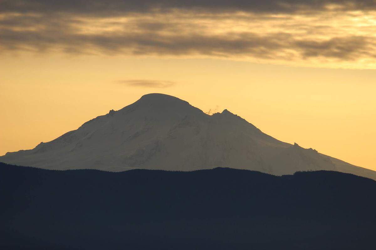 A small lenticular cloud forms above Mount Baker as steam or gas vents from Sherman Crater before dawn on Saturday, March 2, 2019, east of Bellingham, WA.