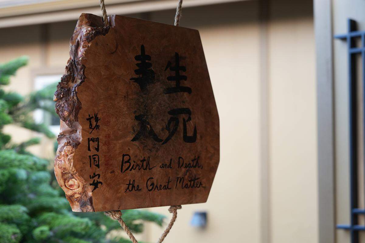 A wooden sign outside of the Red Cedar Zen Community Buddhist Temple is used as part of the meditation practice.