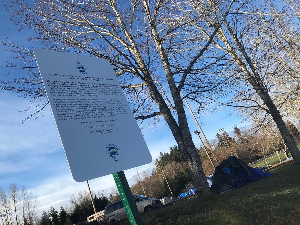 City workers put up news signs Tuesday, March 9, near the homeless camp at Frank Geri Softball Fields in the Puget neighborhood of Bellingham.