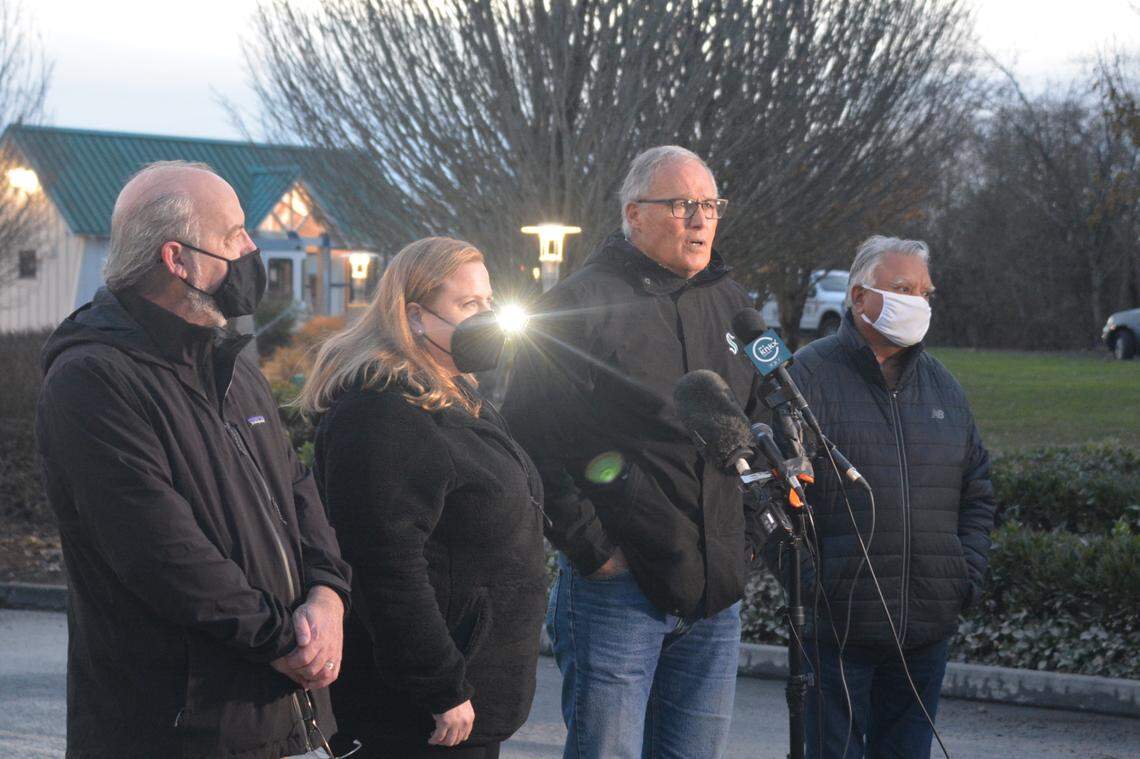 Ferndale Mayor Greg Hansen, left, state Rep. Alicia Rule, Gov. Jay Inslee and Whatcom County Executive Satpal Sidhu discuss the devastation they saw Wednesday, Nov. 17, during a tour of flood-affected areas in Everson.