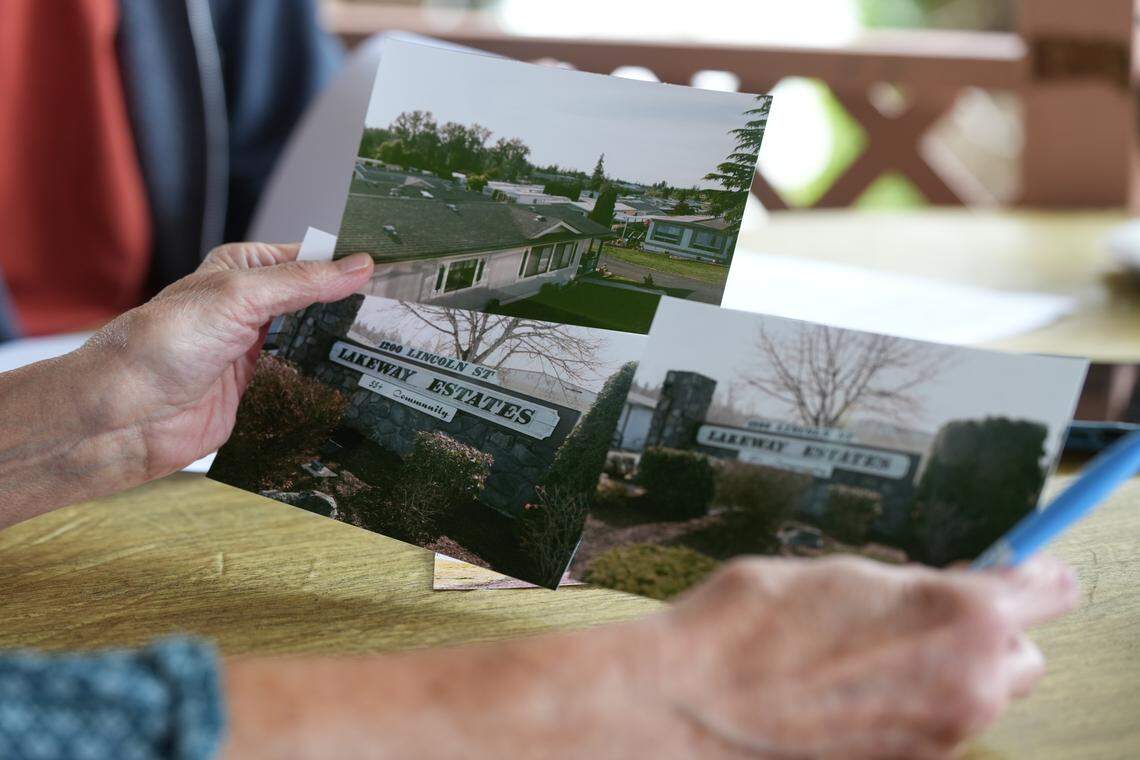 A resident of Lakeway Estates holds undated photos of the manufactured home park.