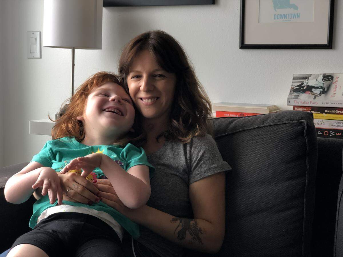 Jenn Mason, right, sits with her daughter Luella Mason-Estes, 6, in her apartment in downtown Bellingham Aug. 9. When school isn’t in session, Mason often spends days with her daughter and gets her work done after she’s gone to sleep.