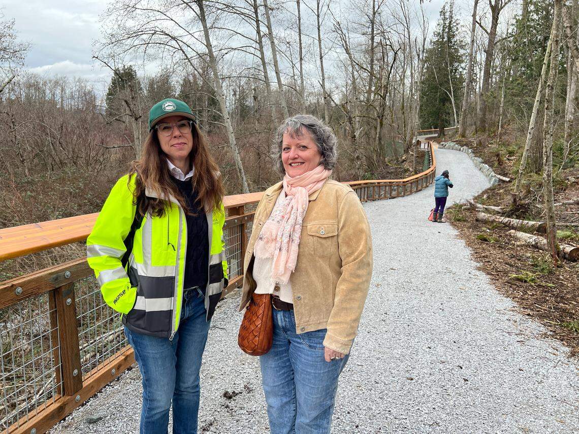 Nicole Oliver, director of the Bellingham Parks and Recreation Department (right) and parks project engineer Gina Austin walk a new trail at Sunset Pond on Wednesday in Bellingham.