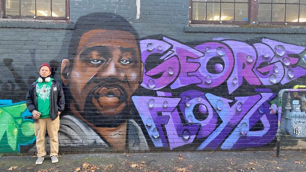 Taj Williams, with the mural he painted of George Floyd in an alley near Magnolia Street in Bellingham on Friday, Jan. 15. Floyd’s death sparked nationwide protests against police brutality in the summer of 2020.
