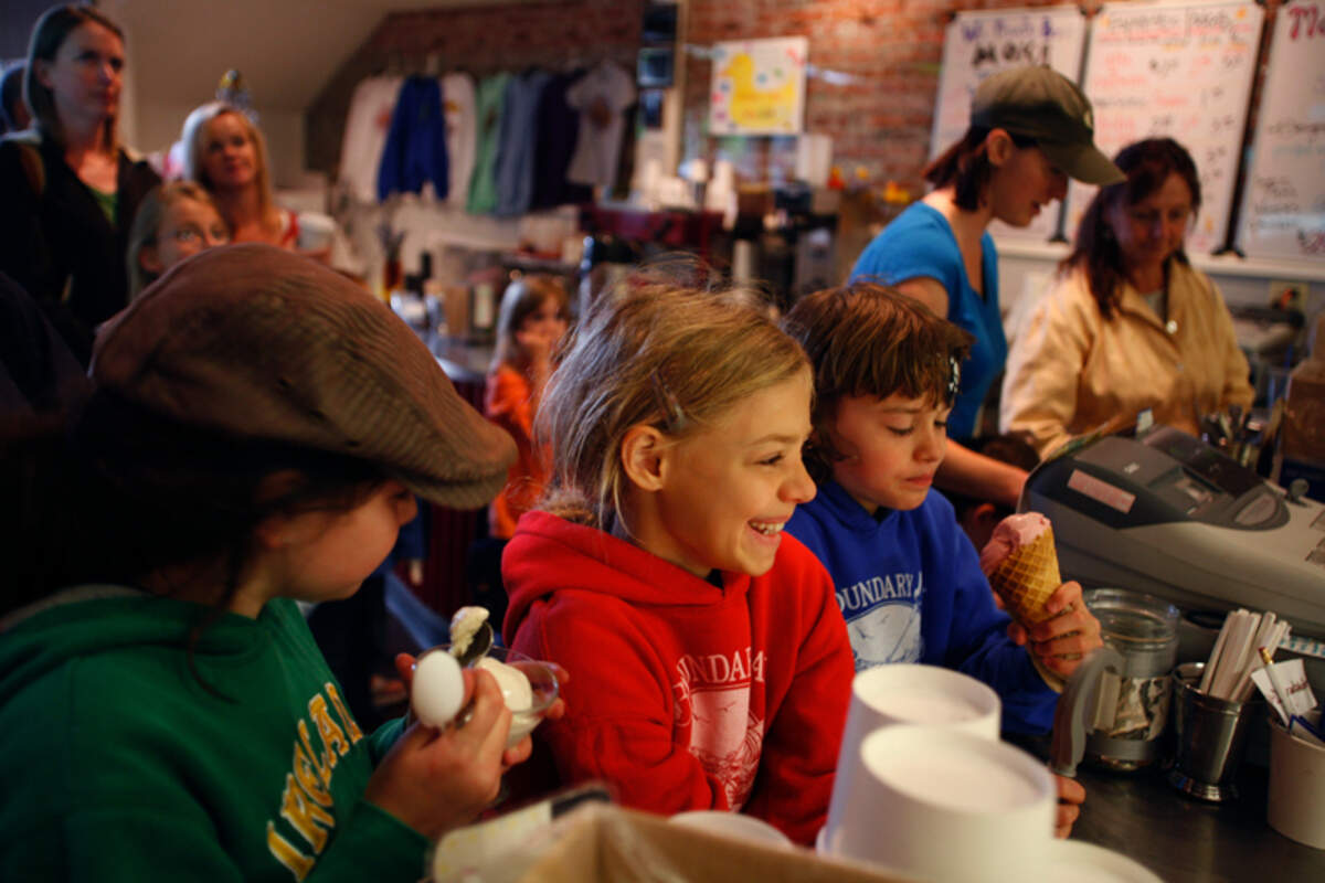 From left, Emily Whitehall, Sienna Templeton and Chedar Templeton, all 10, wait in line at Mallard Ice Cream, 1323 Railroad Ave. in Bellingham.