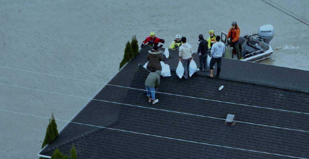 A rooftop rescue in Sumas is shown in an undated aerial photo from the Washington Governor’s Office that was included in a Jan. 21, 2026, appeal for a federal disaster declaration from President Trump.