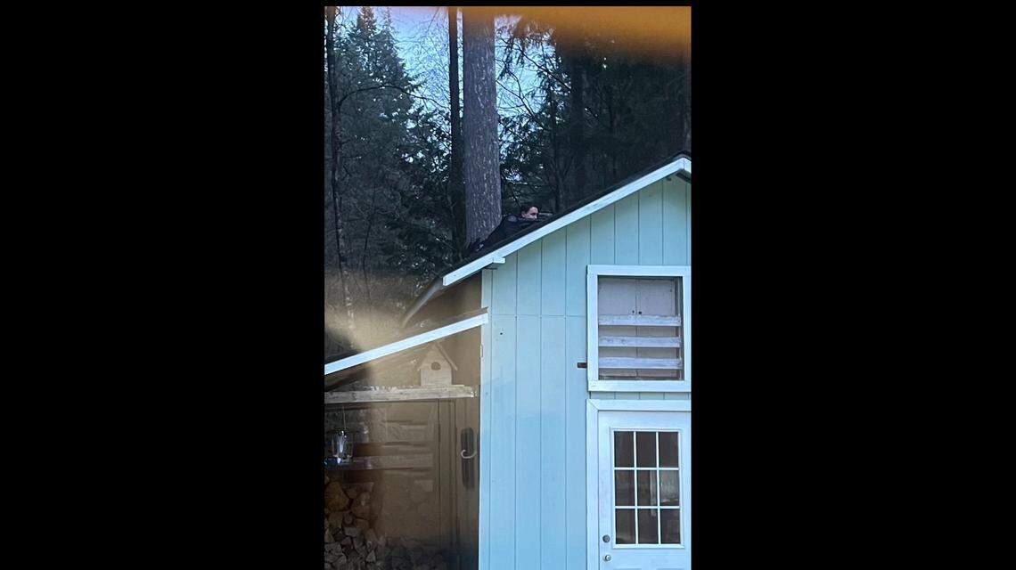 A law enforcement officer takes a position on a Peaceful Valley home Thursday, Feb. 10. Law enforcement was investigating the shooting of two Whatcom County Sheriff’s Office deputies who were reportedly trying to break up a neighborhood dispute in which two people were shooting at each other.