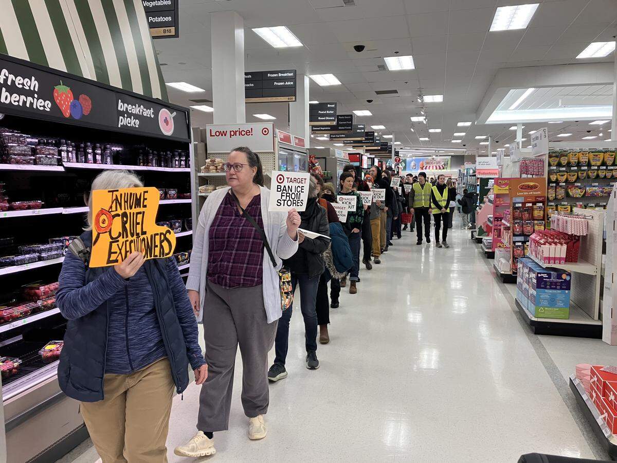 More than 50 community members marched through Target in Bellingham on Saturday.