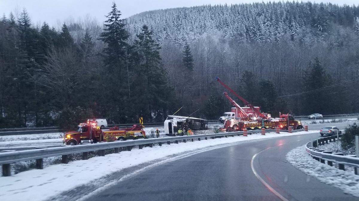 Tow trucks work to remove a semi-truck involved in the earlier rollover on southbound Interstate 5 south of Bellingham that blocked all lanes early Wednesday, Nov. 30.