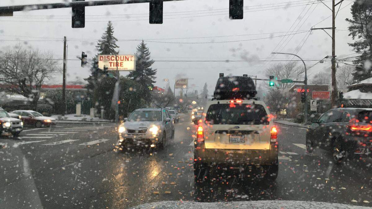 Traffic stops as snow falls at Lakeway Drive and Lincoln Street in the Puget neighborhood of Bellingham in 2020.