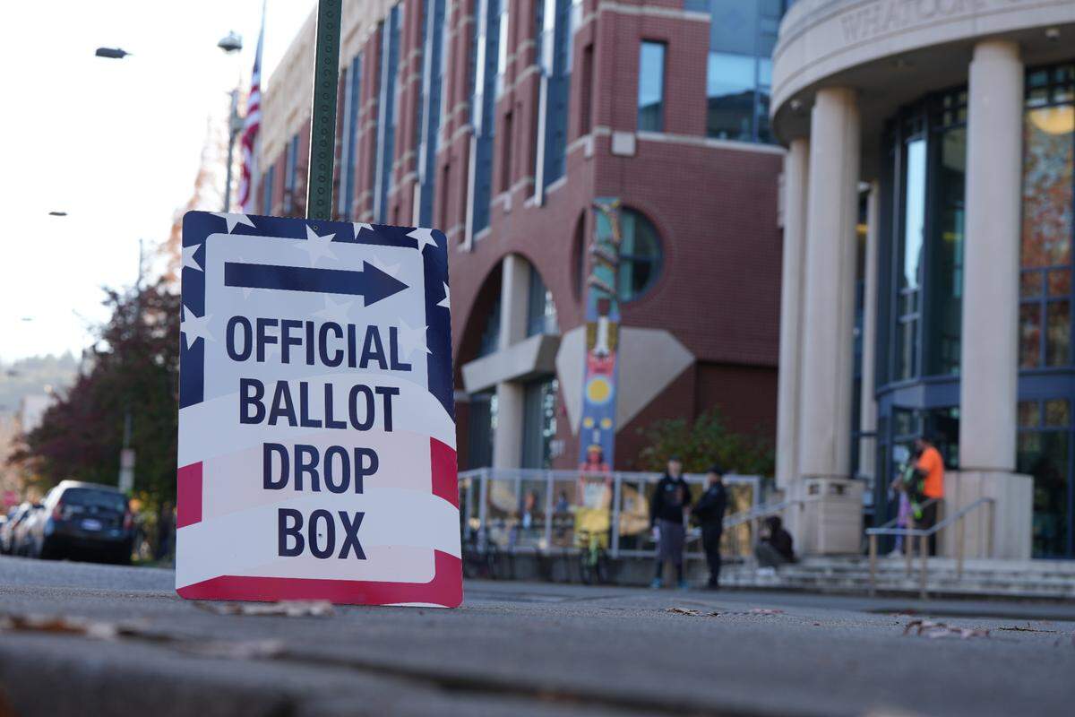 A sign points people toward an official ballot drop box outside of the Whatcom County Courthouse in Bellingham.