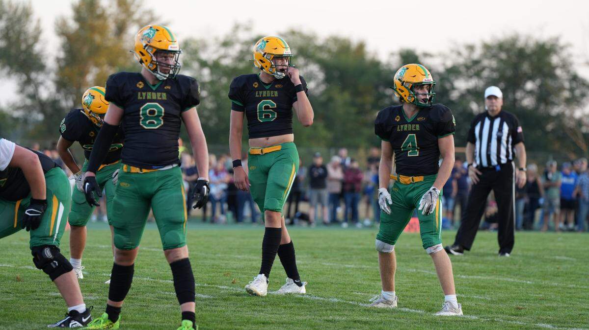 Charlie Ayers, right, prepares to get into formation with his Lynden teammates Brant Heppner and Isaiah Oudman, left, in the first big game of the season against Ferndale on Sept. 1, 2023, in Lynden, Wash. Ferndale won against Lynden.