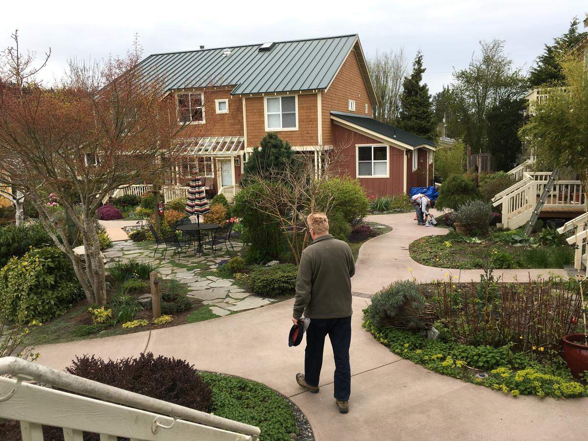Ed Simmers walks toward his home in a co-housing project, which is part of Happy Valley's broad range of housing options.