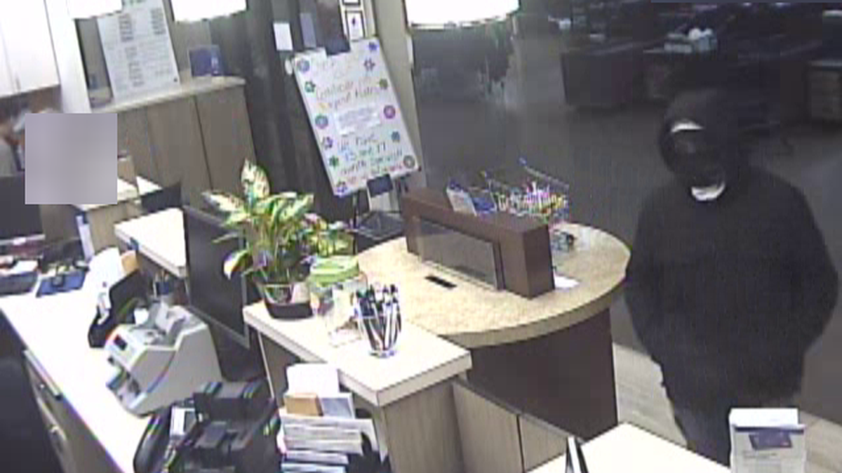 Surveillance video shows a man suspected of robbing Banner Bank within a Main Street grocery store about 4:30 p.m. Tuesday, Jan. 24, in Ferndale. Ferndale Police say the man is described as white, about 5 feet, 9 inches tall with a regular build, wearing a black hoodie with the hood pulled up, a black face covering, blue latex-type gloves, faded baggie blue jeans and white shoes.