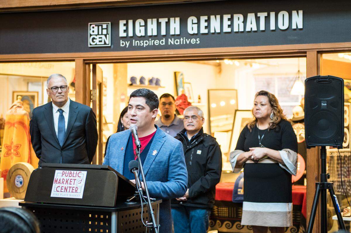 Eighth Generation Founder Louie Gong speaks at an event attended by Washington Gov. Jay Inslee outside the flagship store in Seattle’s Pike Place Market on Monday, Nov. 25. Gong announced the sale of the company to the Snoqualmie Indian Tribe. He will remain at the company as CEO.
