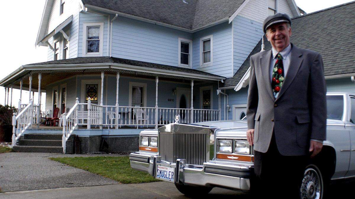 Bob Boule stands outside his Smuggler’s Inn Bed and Breakfast with his ’87 Cadillac stretch limousine in 2004, in Blaine.