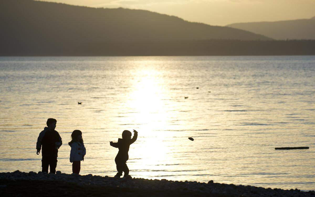 Bellingham residents enjoy a sunset at Boulevard Park in 2014. Bellingham was one of 14 towns included on Forbes' recent list of "Coolest towns for your summer vacation," which it said included "quirky, character-filled small towns that are anything but sleepy."