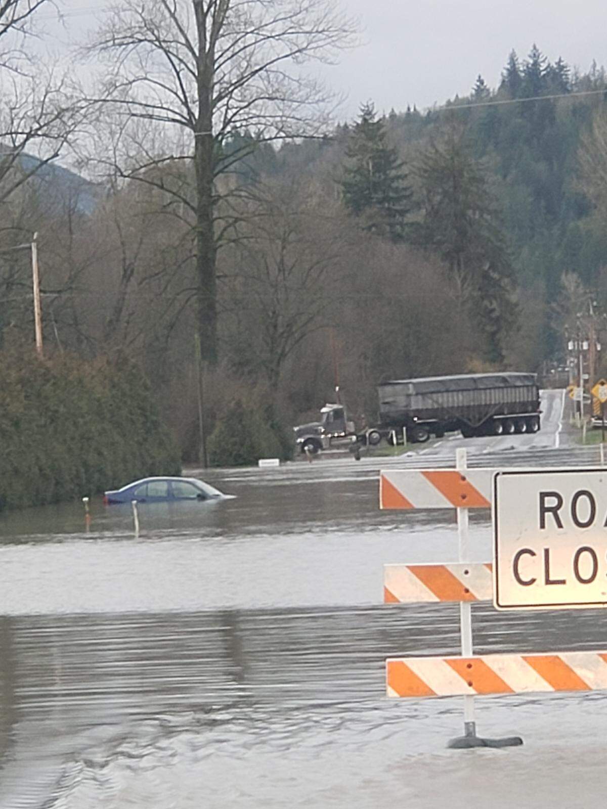 A car is stopped in Nooksack River floodwaters on Highway 9 near Acme on Saturday.