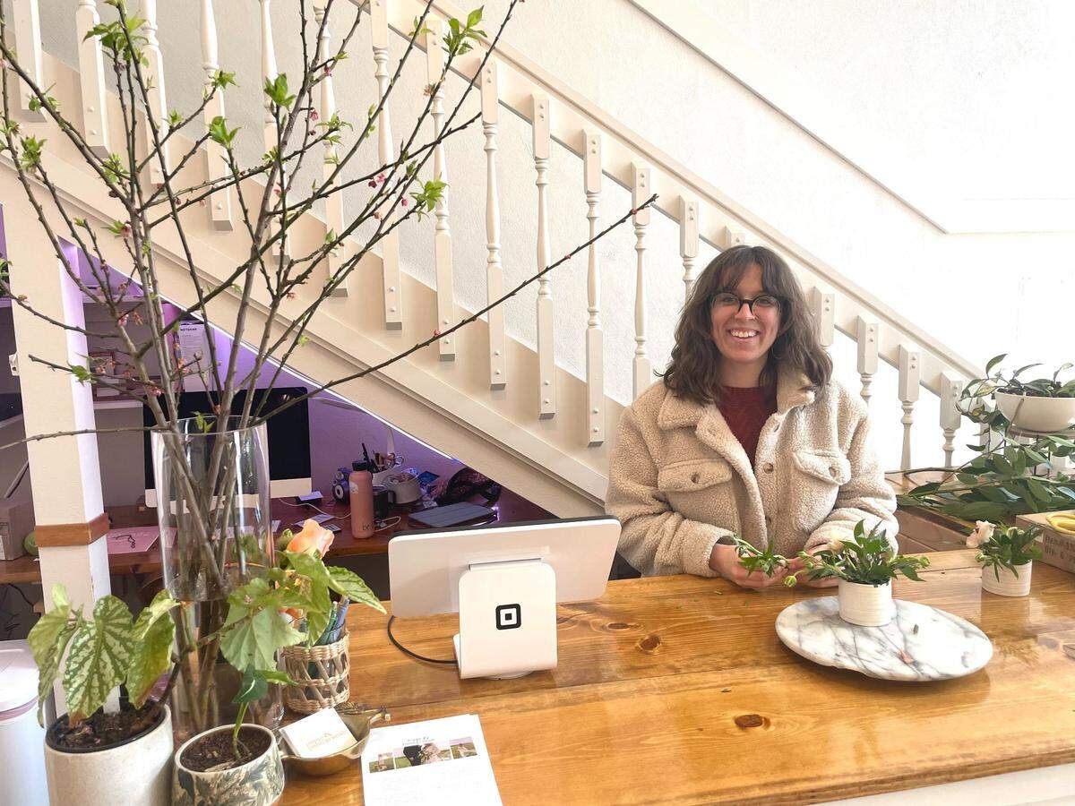 Elyse Parron, owner of Poppy & Pomegranate, makes a bouquet in 2023.
