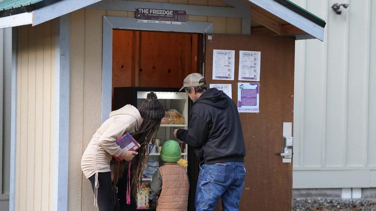 Community members use the new “Freedge” at the North Fork Library in Kendall.