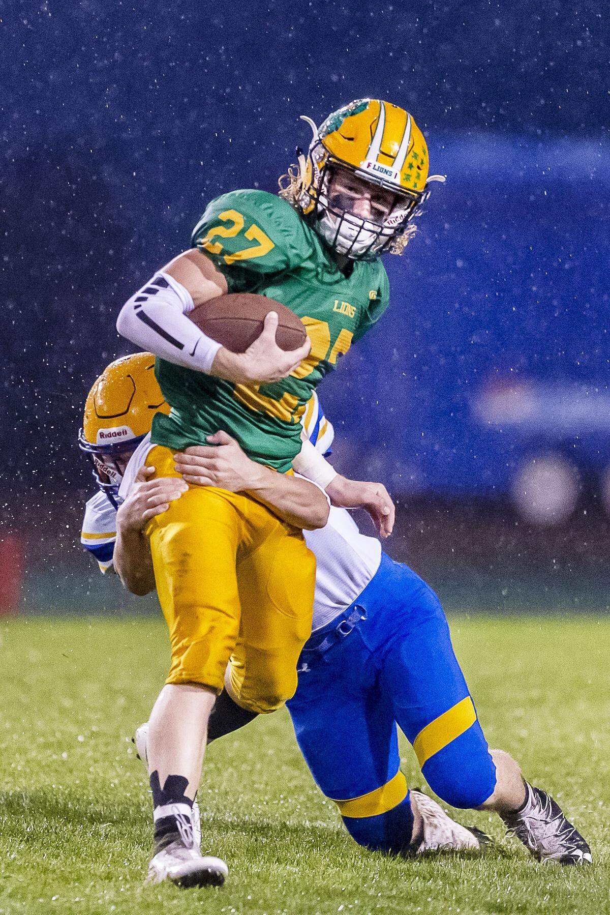 Lynden wide receiver Grant VanderYacht tries to fight through a tackle attempt by Ferndale defensive back Michael Bernard late in the second quarter during a rainy Friday evening Sept. 7 at Lynden High School.
