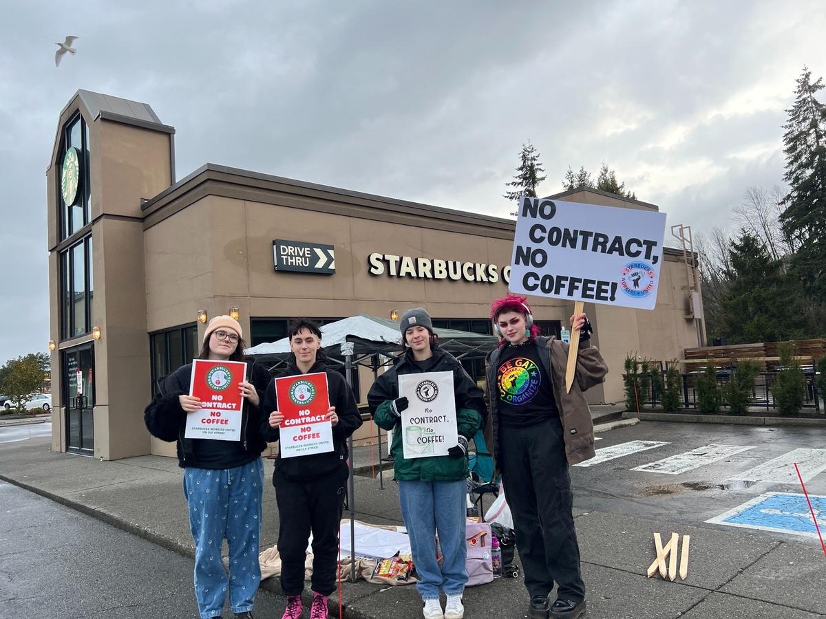 Starbucks union baristas picket outside the company’s coffee shop in the Sehome Village shopping center on Tuesday.