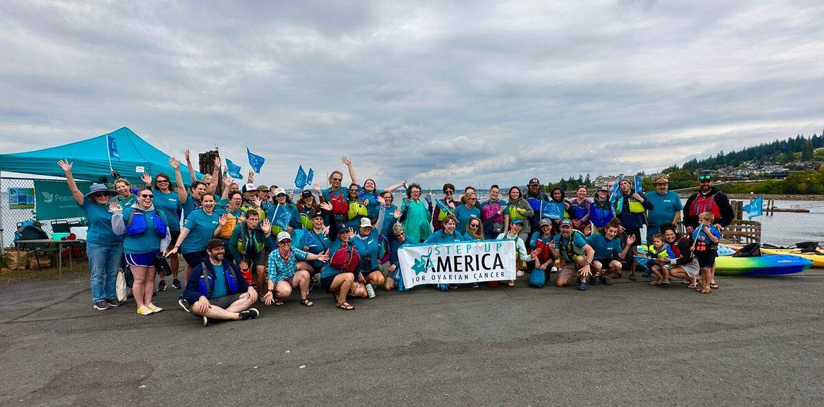 Participants in the 2023 Ride the Teal Wave fundraiser pose for a picture.