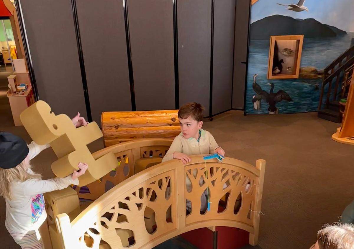 A photo of a family at Low Sensory Sunday at the Whatcom Museum, with foam wall partitions set up, at the Lightcatcher & Family Interactive Gallery 250 Flora St, in Bellingham, Wash.