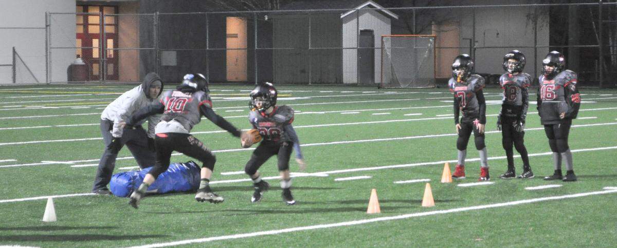 The Bellingham Knights youth football team goes through practice drills Wednesday at Bellingham High School. The Knights, who are made up of 9- and 10-year-old players, head to Canton, Ohio, this week to play in the 2018 World Youth Championship.