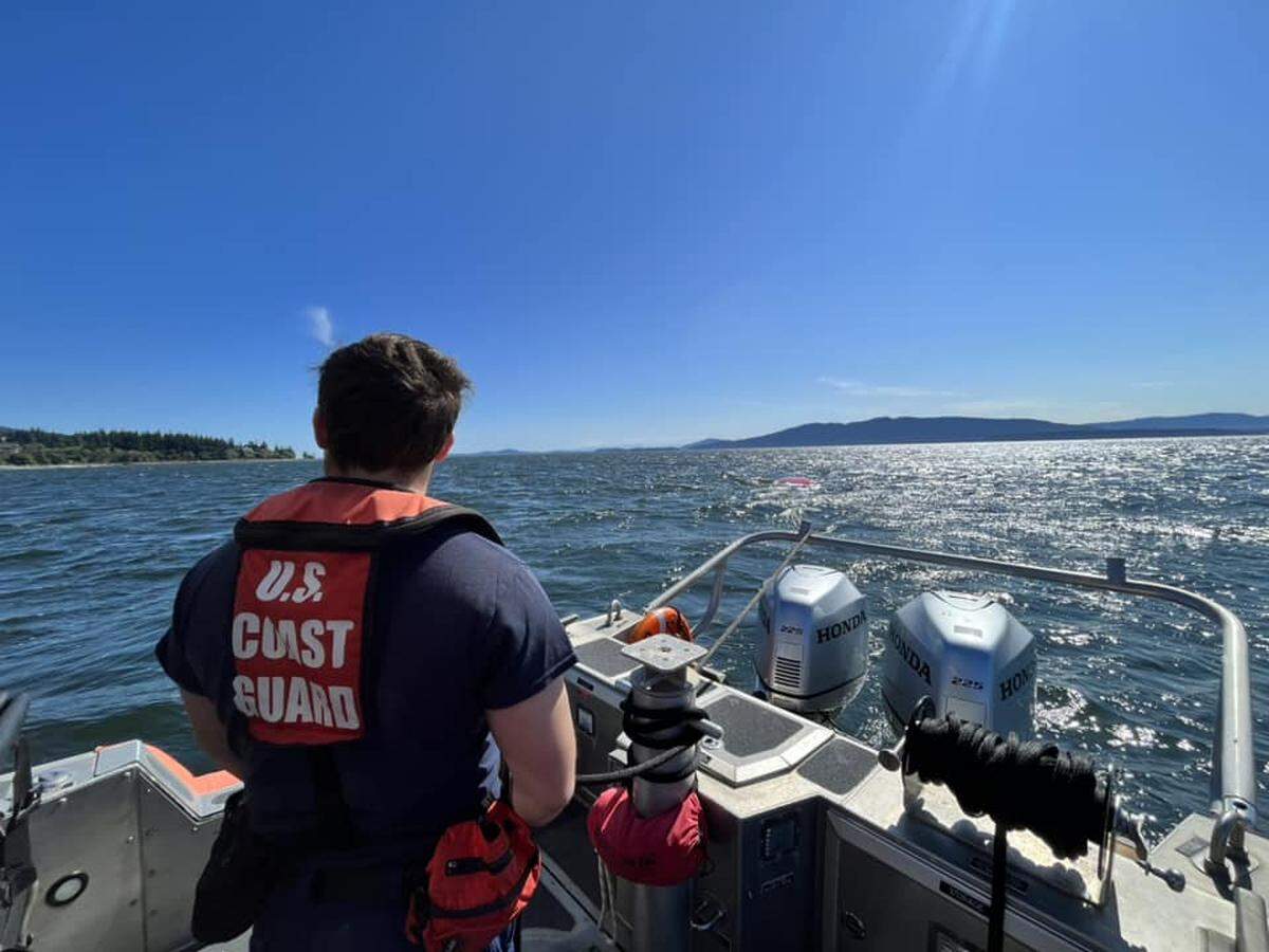The U.S. Coast Guard team stationed in Bellingham approaches an overturned sailboat on Bellingham Bay on the weekend of July 22, 2023. No injuries were reported and the boat was brought back to the boat launch.