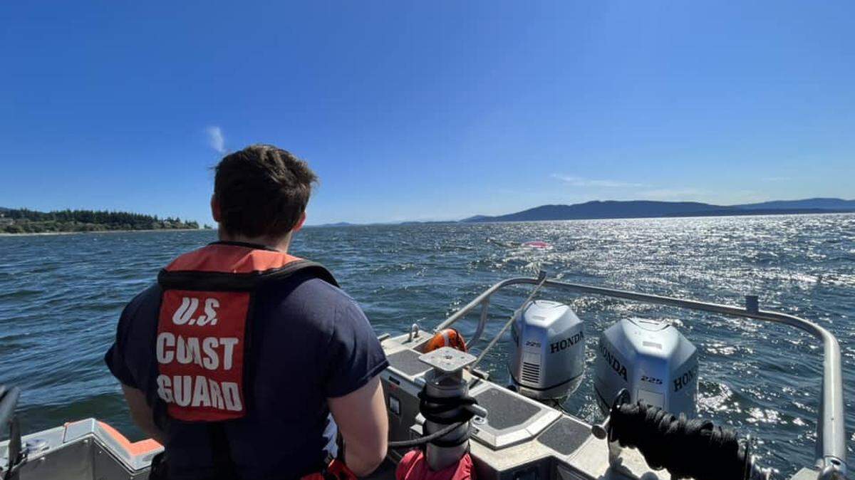The U.S. Coast Guard team stationed in Bellingham approaches an overturned sailboat on Bellingham Bay in 2023.